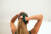 Load image into Gallery viewer, Tying up your hair with the Emerald Scrunchie

